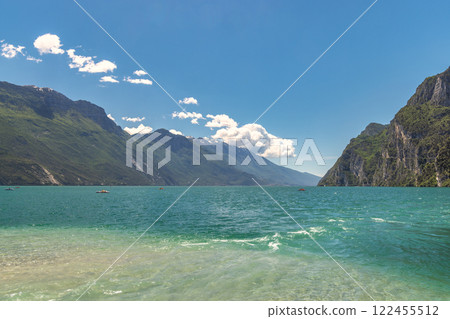 Lake Garda with mountains in background, view from beach in Riva del Garda town, Italy, Europe. Lake Garda with mountains in background, view from beach in Riva del Garda town, Italy, Europe. 122455512