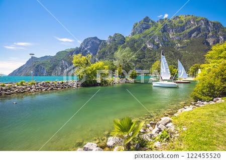 Lake Garda with mountains in background, view from beach in Riva del Garda town, Italy, Europe. Lake Garda with mountains in background, view from beach in Riva del Garda town, Italy, Europe. 122455520