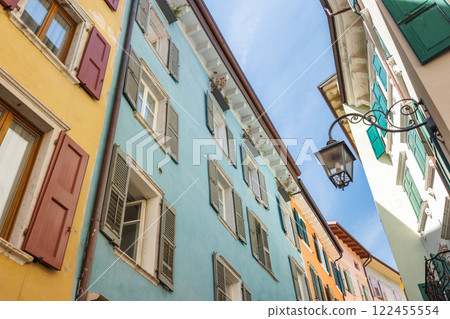 Colorfull buildings in a street of the Riva del Garda, town on the shores of Lake Garda, Italy, Europe. Colorfull buildings in a street of the Riva del Garda, town on the shores of Lake Garda, Italy, Europe. 122455554