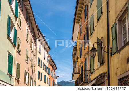Colorfull buildings in a street of the Riva del Garda, town on the shores of Lake Garda, Italy, Europe. Colorfull buildings in a street of the Riva del Garda, town on the shores of Lake Garda, Italy, Europe. 122455557