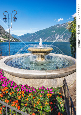 A fountain on the shores of Lake Garda in Limone Sul Garda town, Italy, Europe. A fountain on the shores of Lake Garda in Limone Sul Garda town, Italy, Europe. 122455572