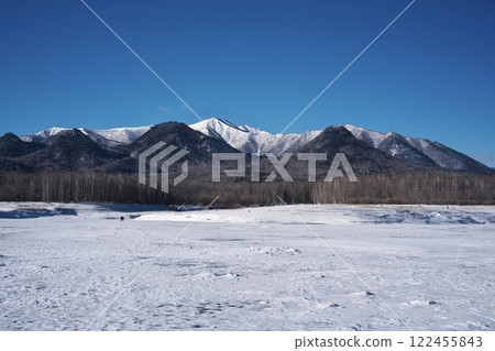 View of the snowy mountains from the completely frozen Lake Nukabira View of the snowy mountains from the completely frozen Lake Nukabira 122455843