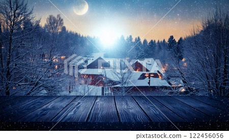 Winter equinox evening with tranquil snow-covered landscape and cozy cabins 122456056
