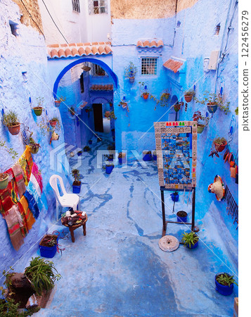 Blue Streets Of Chefchaouen In Morocco: A Serene And Picturesque Alleyway With Souvenirs For Sale Blue Streets Of Chefchaouen In Morocco: A Serene And Picturesque Alleyway With Souvenirs For Sale 122456279
