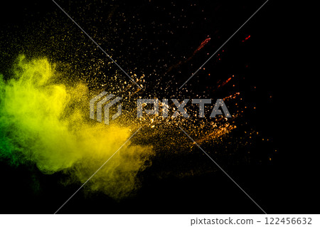 Colorful explosion of powdery dust is captured in a yellow and green cloud Colorful explosion of powdery dust is captured in a yellow and green cloud 122456632