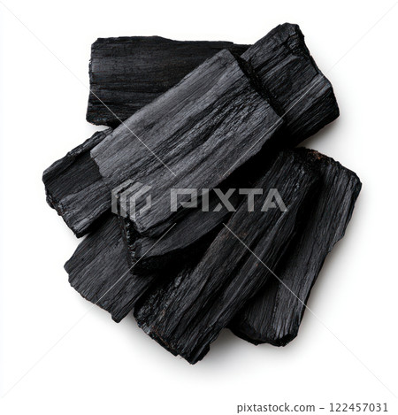 Organic charcoal pieces stacked on a clean surface. isolated on white background. 122457031
