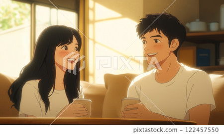 A young Asian couple is drinking coffee in the living room and having a very happy conversation. 122457550
