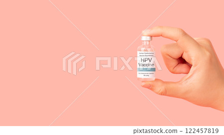 Hand holding human papillomavirus (HPV) vaccine bottle isolated pink background. HPV vaccine protects against certain types of HPV that can cause cervical cancer. 122457819