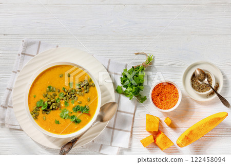 Pumpkin Red Lentil Soup in white bowl, top view 122458094