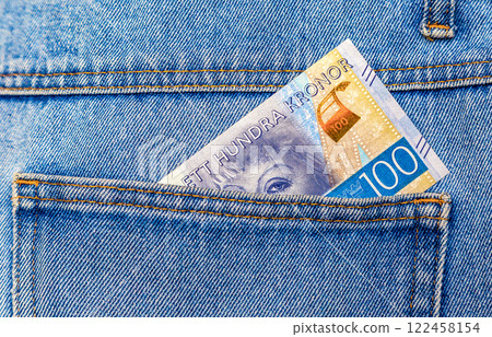 Swedish crown banknote sticking out of the pocket of pocket 122458154