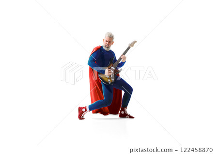 Grey-haired young man in superhero costume playing electric guitar, looking like a Rockstar against white studio background 122458870