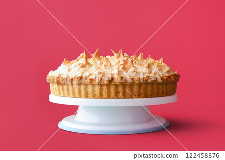 Homemade lemon meringue pie isolated on a pink background Homemade lemon meringue pie isolated on a pink background 122458876