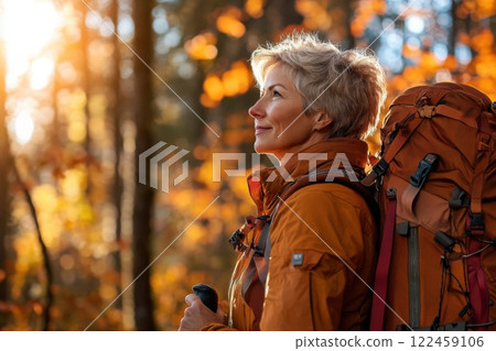 Middle aged woman begins her hiking journey on a sunny autumn day in the forest Middle aged woman begins her hiking journey on a sunny autumn day in the forest 122459106