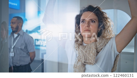 Adult Woman Passes Through Metal Detector Gates for Boarding Plane Flight 122460131