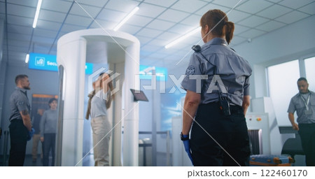 Woman Passes Through Metal Detector Scanner. Female Security Officer Checks Passenger, Ticket 122460170