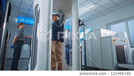 Diverse People Passing Through Metal Detector Gates in Airport Terminal Diverse People Passing Through Metal Detector Gates in Airport Terminal 122460180