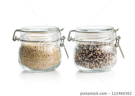 Mixed and white uncooked quinoa seeds in jars isolated on white background. 122460362