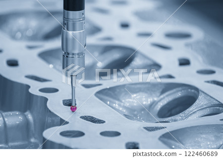 The CMM machine measuring the aluminum cylinder head parts in the light blue scene. The CMM machine measuring the aluminum cylinder head parts in the light blue scene. 122460689