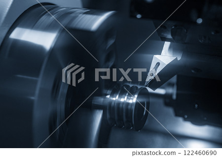The  CNC lathe machine forming  cutting the metal shaft parts in the light blue scene. 122460690