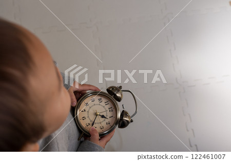 Toddler and clock 122461007