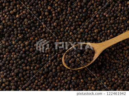 Dry black pepper seeds, top view. Flat design. Macro spice background. Dry black pepper seeds, top view. Flat design. Macro spice background. 122461942