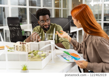 Two young architects working together on a new sustainable project Two young architects working together on a new sustainable project 122462019