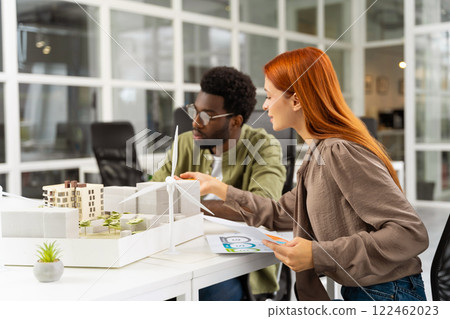 Two young architects working together on a new sustainable project 122462023