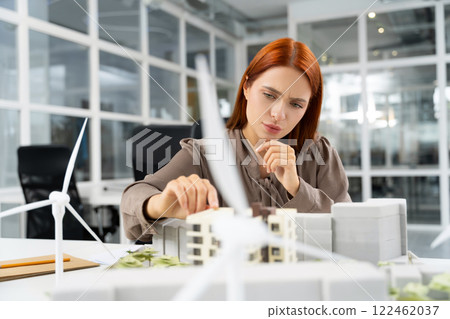 Young female architect working on a project and looking focused Young female architect working on a project and looking focused 122462037