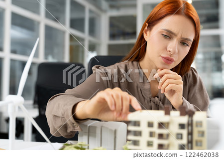 Young female architect working on a project and looking focused Young female architect working on a project and looking focused 122462038