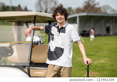 Dark-haired caucasian young golfer with a brassie in hand 122462109
