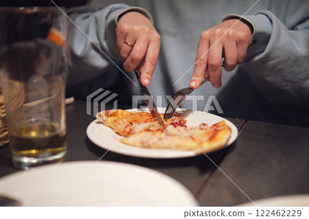 Freshly prepared thin crust pizza with chili peppers on a dark table in an Italian restaurant Freshly prepared thin crust pizza with chili peppers on a dark table in an Italian restaurant 122462229