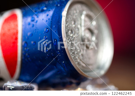 Close-up of a can of coca cola. Pepsi advertisement. Iron can of cola on a table with ice cubes 122462245