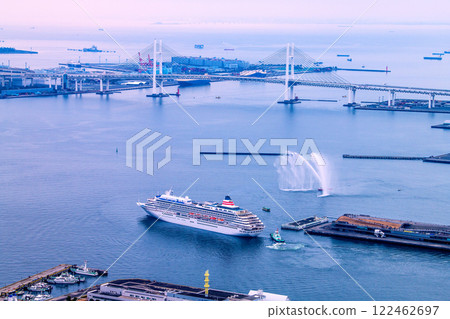 Yokohama cityscape in Japan. Departing port. View of Asuka II and others leaving Osanbashi Pier. Car carrier at Daikoku Pier = January 19th 122462697