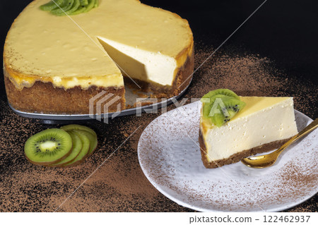 Delicious cheesecake with cottage cheese on the table, decorated with kiwi. 122462937