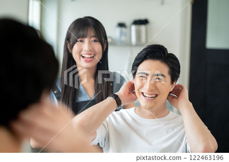 A Japanese man giving hair consultation to a female staff member A Japanese man giving hair consultation to a female staff member 122463196