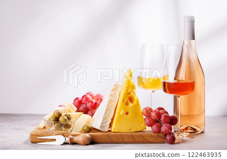 A delectable arrangement of various cheeses, fresh grapes, and wine A delectable arrangement of various cheeses, fresh grapes, and wine 122463935