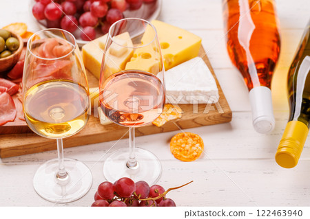 A delectable arrangement of various cheeses, fresh grapes, prosciutto and wine A delectable arrangement of various cheeses, fresh grapes, prosciutto and wine 122463940