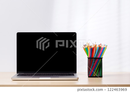 A laptop with a blank screen surrounded by office supplies A laptop with a blank screen surrounded by office supplies 122463969