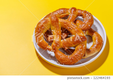 Pretzels scattered across a bright yellow background Pretzels scattered across a bright yellow background 122464193
