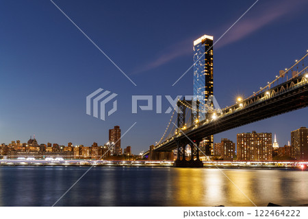 A panoramic sunset view of the Manhattan Bridge stretching towards Manhattan A panoramic sunset view of the Manhattan Bridge stretching towards Manhattan 122464222
