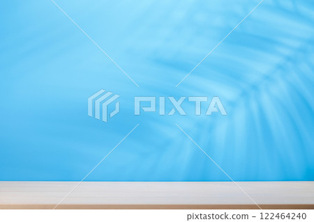 Template with empty table and wall with natural plant shadow and sunny glare 122464240