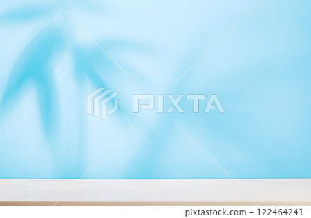 Template with empty table and wall with natural plant shadow and sunny glare 122464241