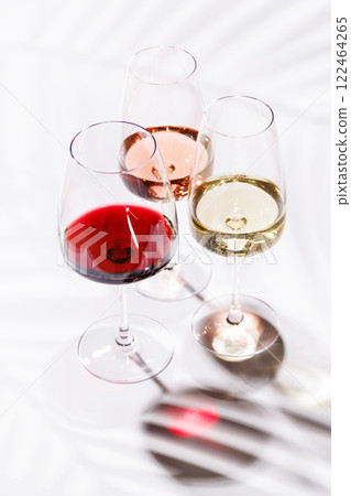 Three wine glasses filled with red, white, and rose wine Three wine glasses filled with red, white, and rose wine 122464265