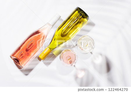 Two wine glasses filled with rose and white wine 122464270