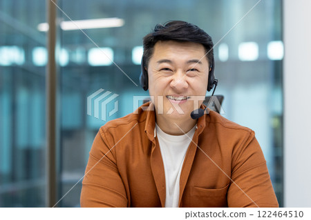 Asian man mature businessman wearing a headset and smiling confidently in a professional work setting, illustrating customer service, communication, and modern office environments. Asian man mature businessman wearing a headset and smiling confidently in a professional work setting, illustrating customer service, communication, and modern office environments. 122464510