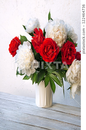 Bouquet of peonies and roses on a table Bouquet of peonies and roses on a table 122464736