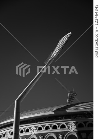 Minimalism, abstraction. A spotlight on the background of the stadium wall. Minimalism, abstraction. A spotlight on the background of the stadium wall. 122464845