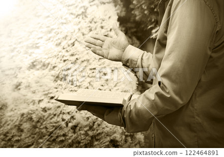 Old man with a bible in his hand 122464891