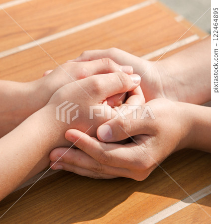 Close-up view of comforting hands Close-up view of comforting hands 122464895