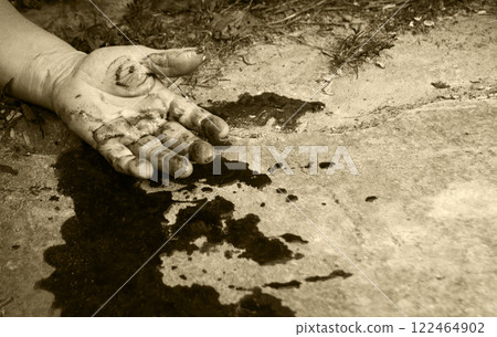 A man's hand in blood lies on the ground A man's hand in blood lies on the ground 122464902